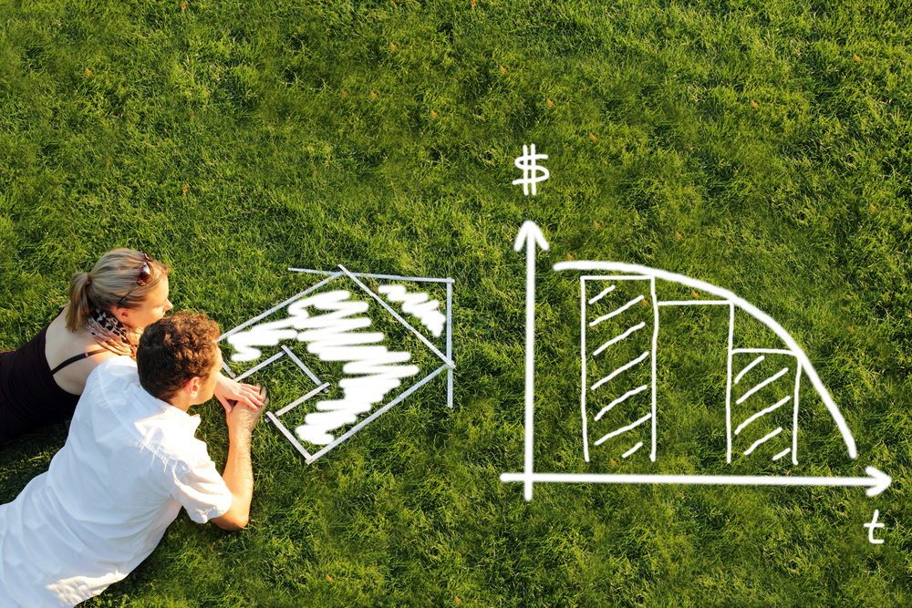 couple on the grass thinking of buying a home