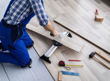 man putting down new floors